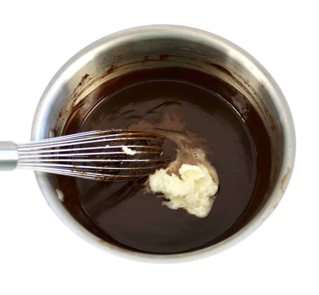 chocolate pudding in saucepan with gelatin and whisk