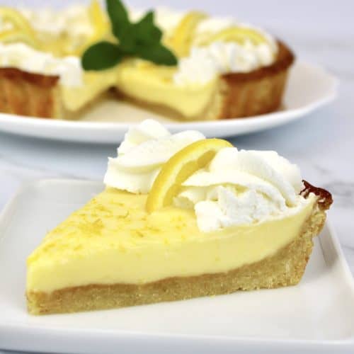 Keto Lemon Mascarpone Tart slice closeup with tart in background