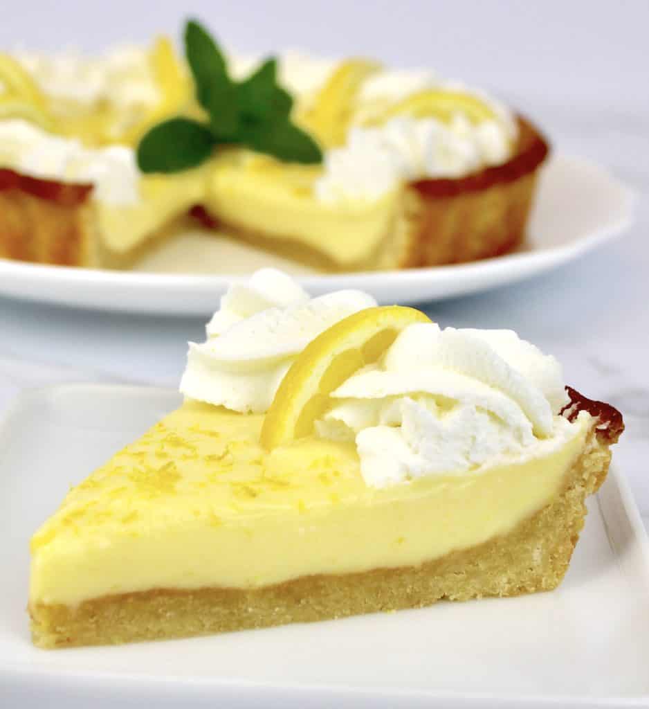 Keto Lemon Mascarpone Tart slice with tart in background