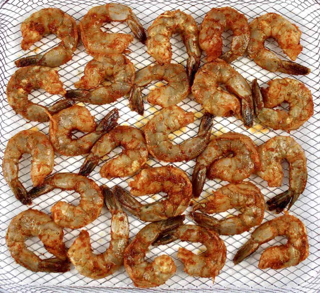 raw blackened shrimp on air fryer rack