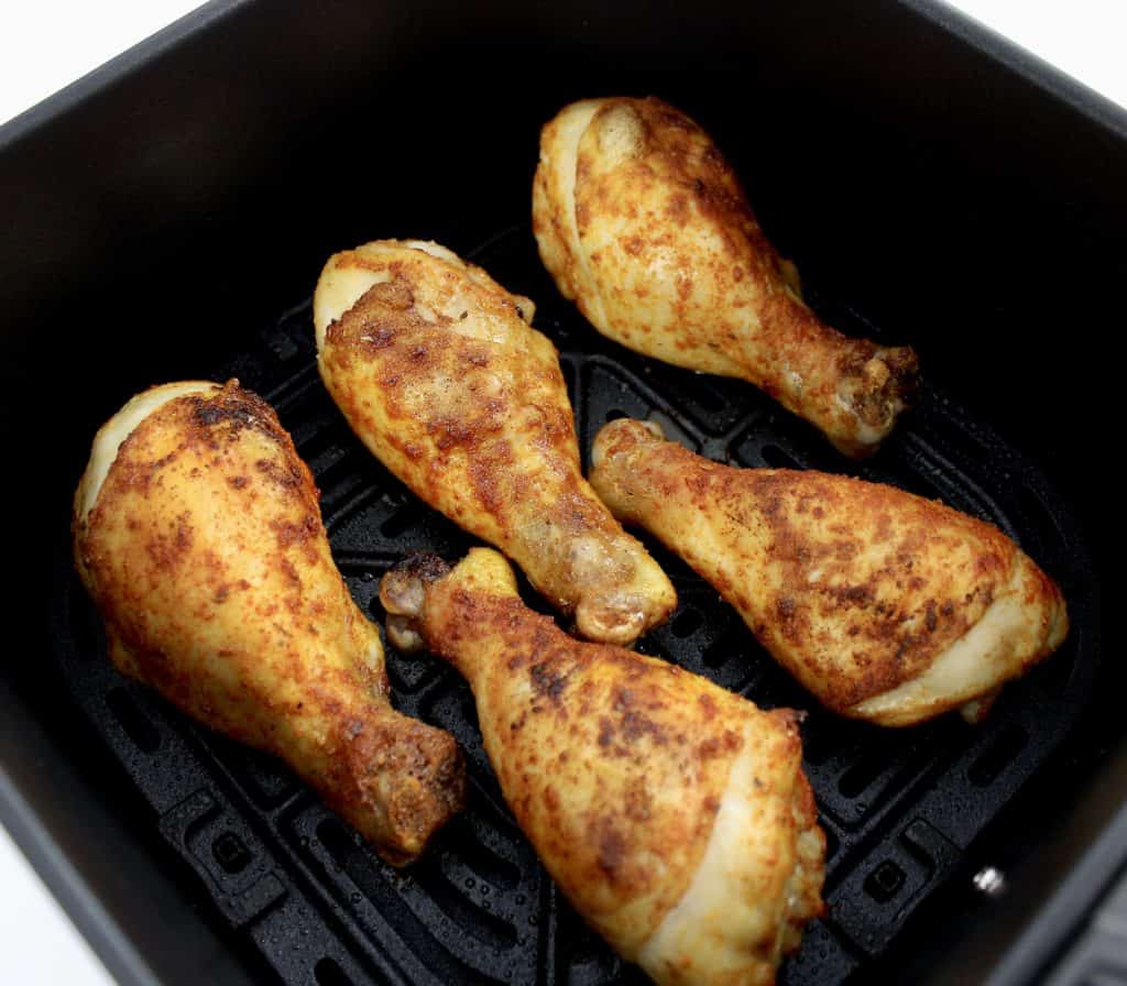 partially cooked chicken legs in air fryer
