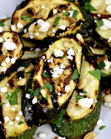 slices of grilled zucchini with feta pine nuts and parsley