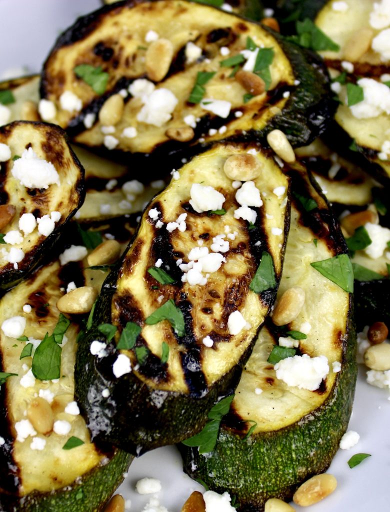 slices of grilled zucchini with feta pine nuts and parsley