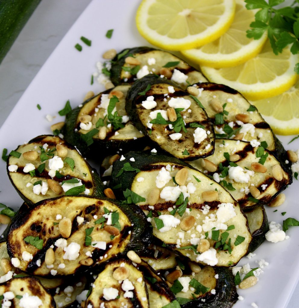 grilled zucchini slices with lemon slices feta and pine nuts