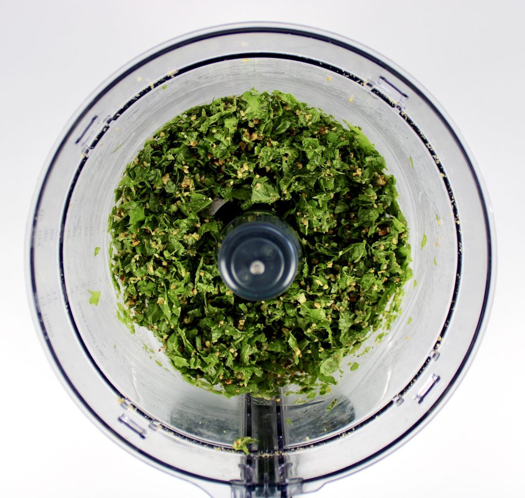 chopped basil and pine nuts in food processor