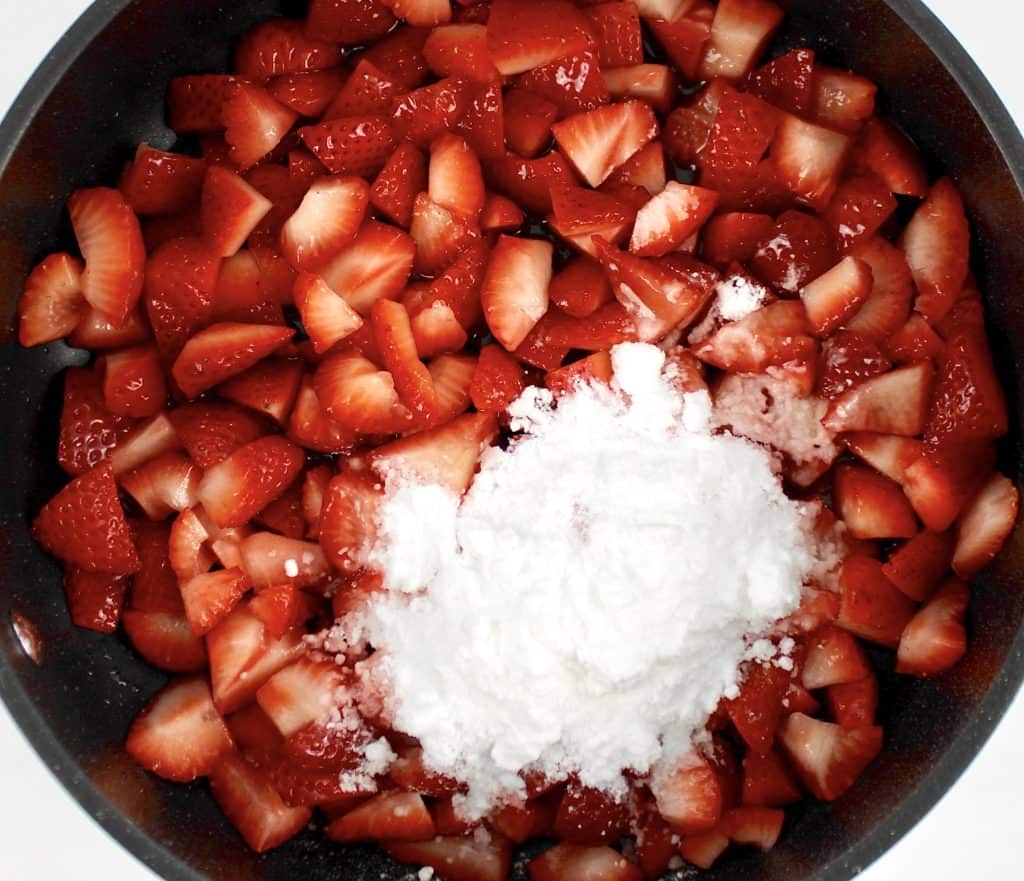 chopped strawberries and sweetener in saucepan