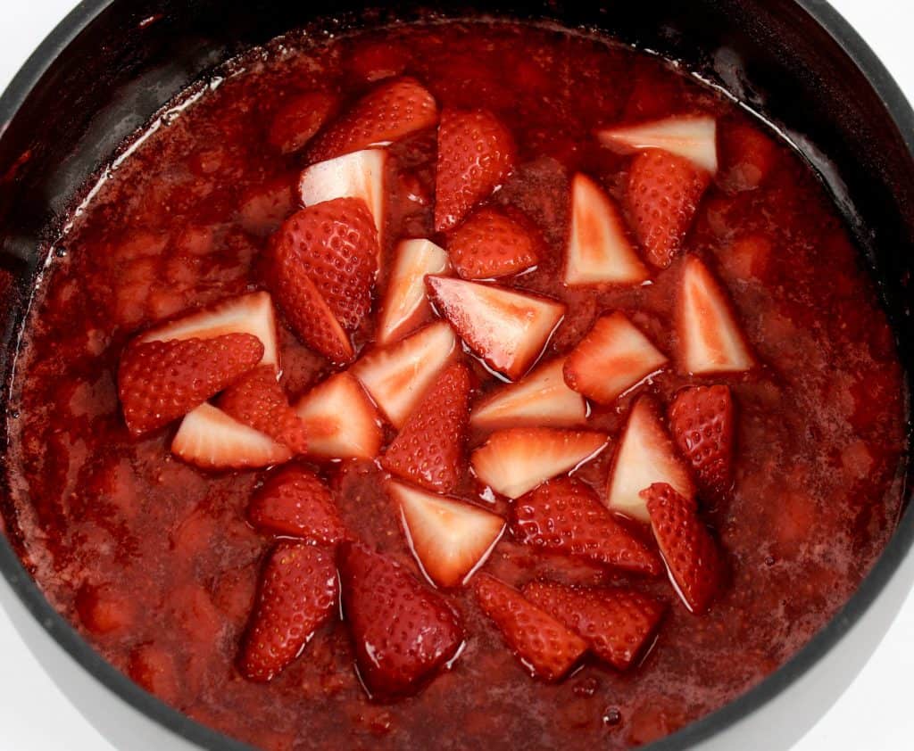 chopped strawberries in saucepan with chunky strawberry sauce