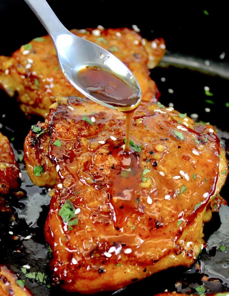 Keto Honey Garlic Chicken with spoon dripping sauce over a piece