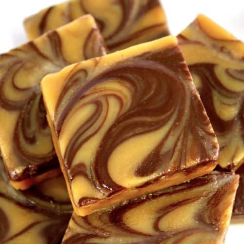 Keto Peanut Butter Chocolate Fudge squares stacked up