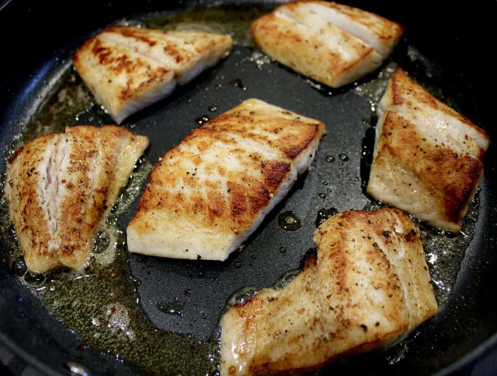 6 pieces of seared snapper in skillet
