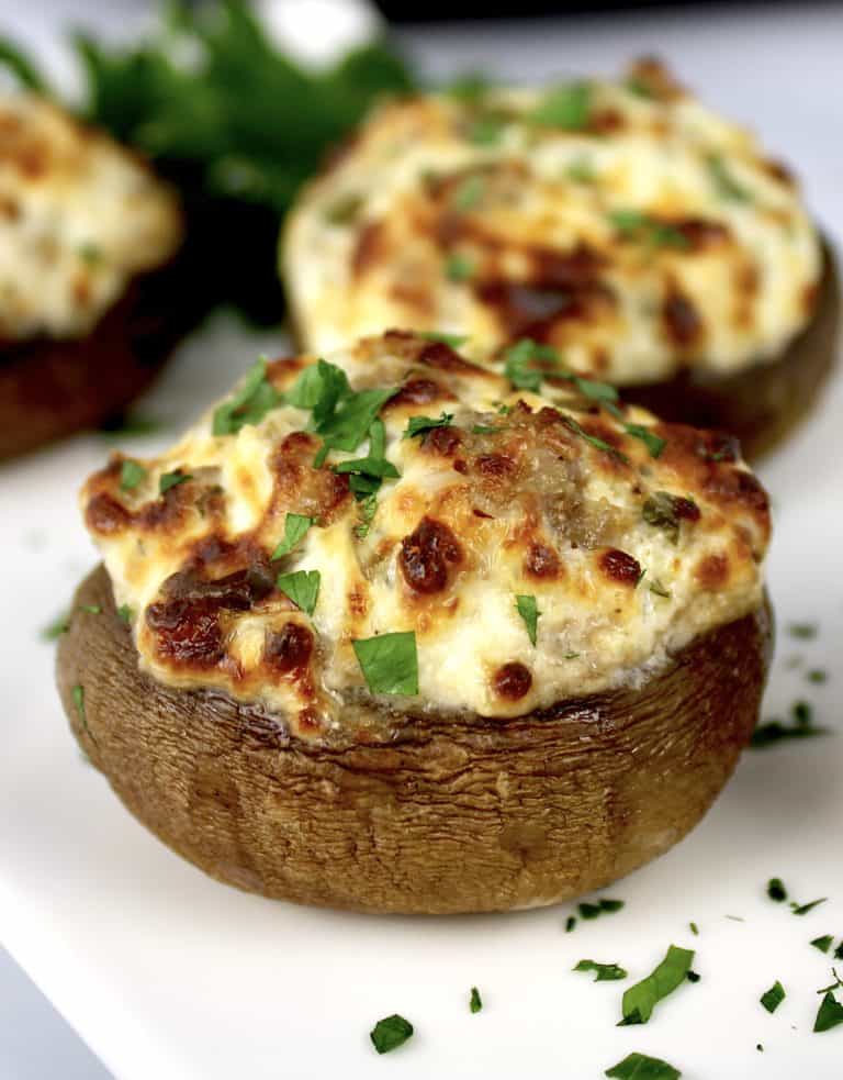 closeup of stuffed mushroom on white plate