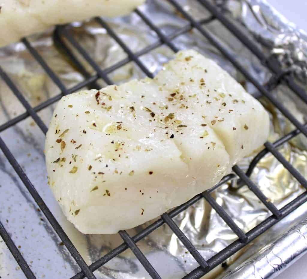 baked cod on baking rack with spices on top