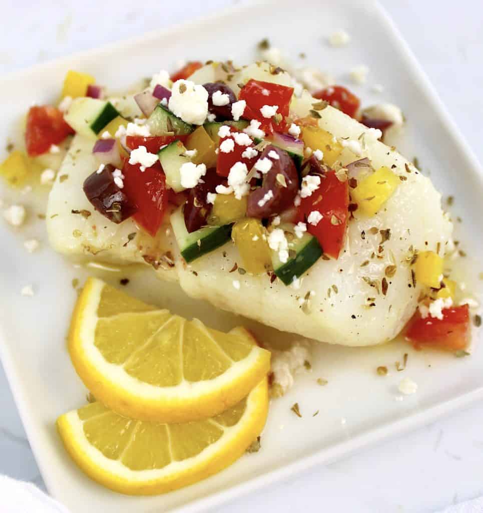 cod with Greek salsa over the top with lemon slices on side