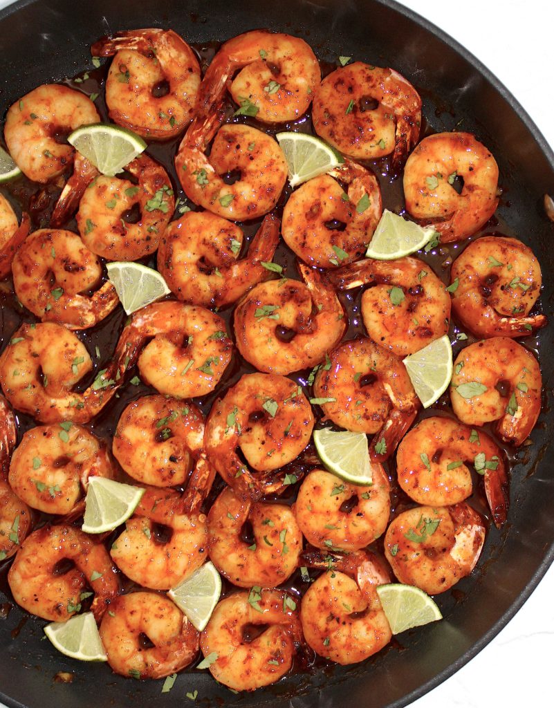 Chili Lime Shrimp in skillet with lime wedges
