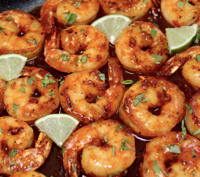 closeup of Chili Lime Shrimp with lime wedges