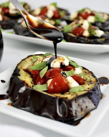 grilled eggplant with tomatoes mozzarella and balsamic being spooned on top