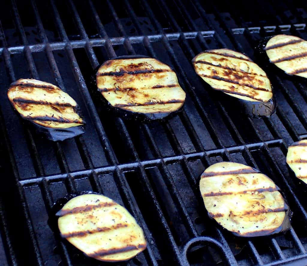 slices of eggplant on grill with grill marks