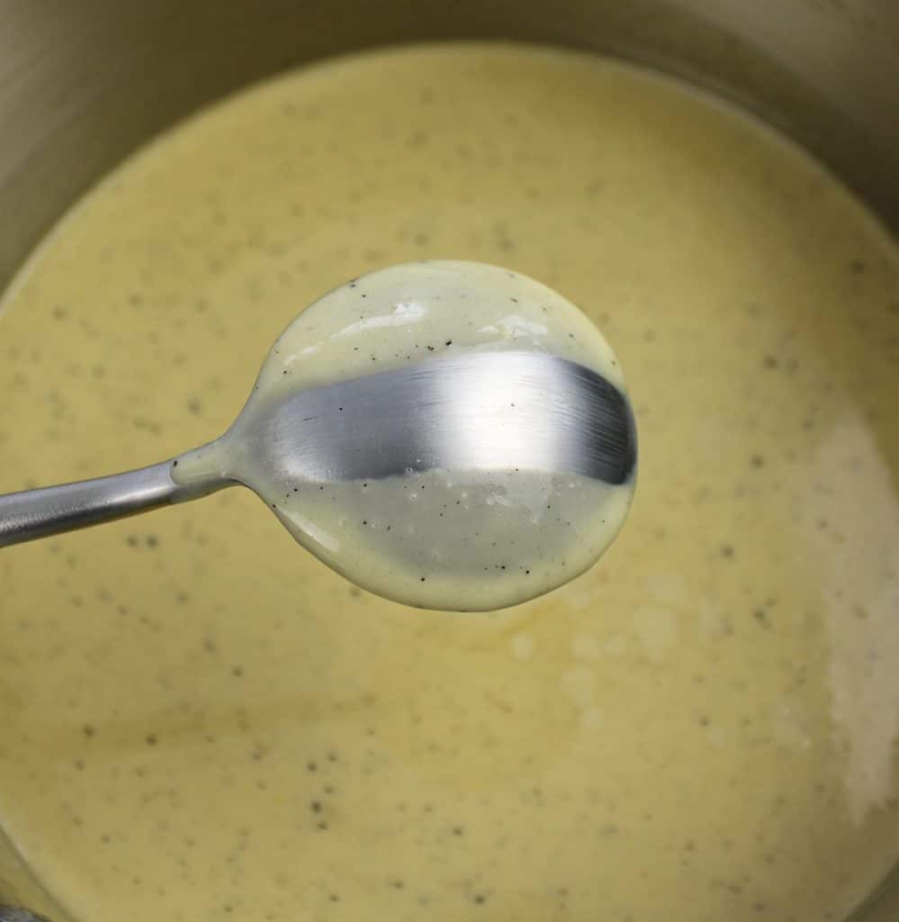 custard in saucepan with some on spoon