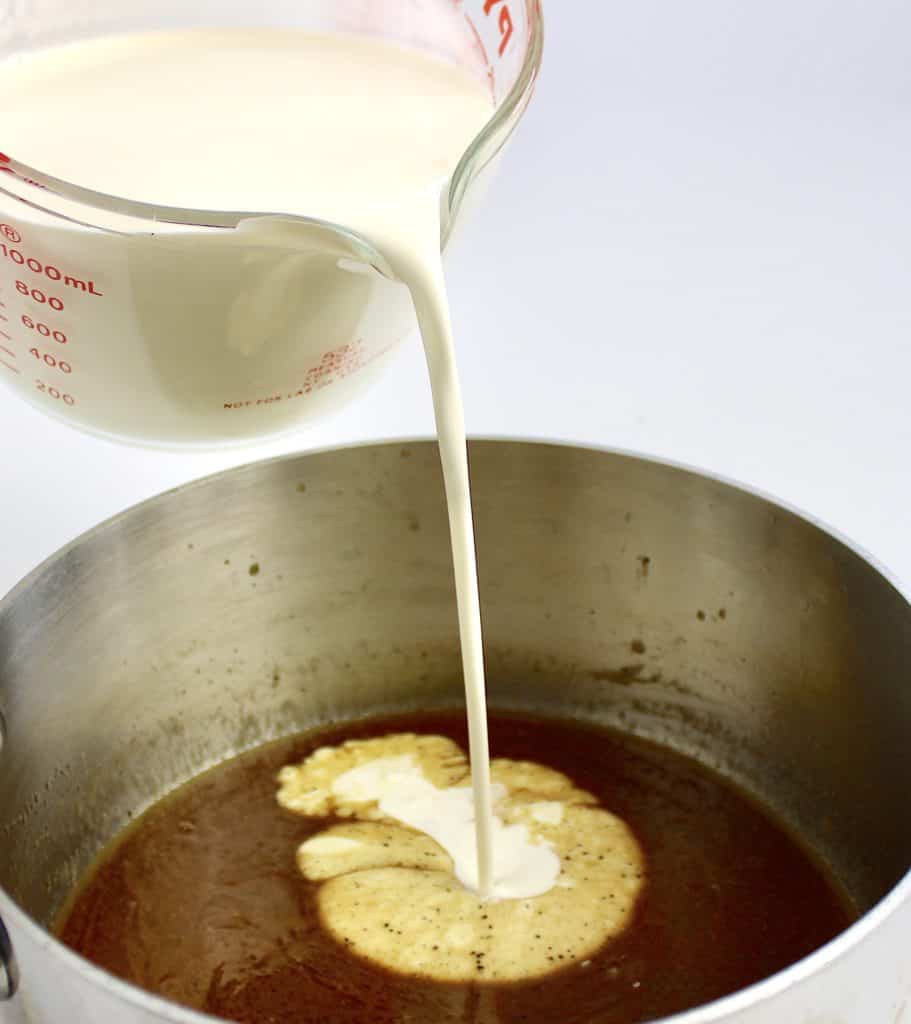 heavy cream being poured into saucepan with brown butter