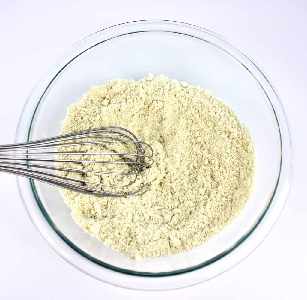 almond flour in glass bowl with whisk