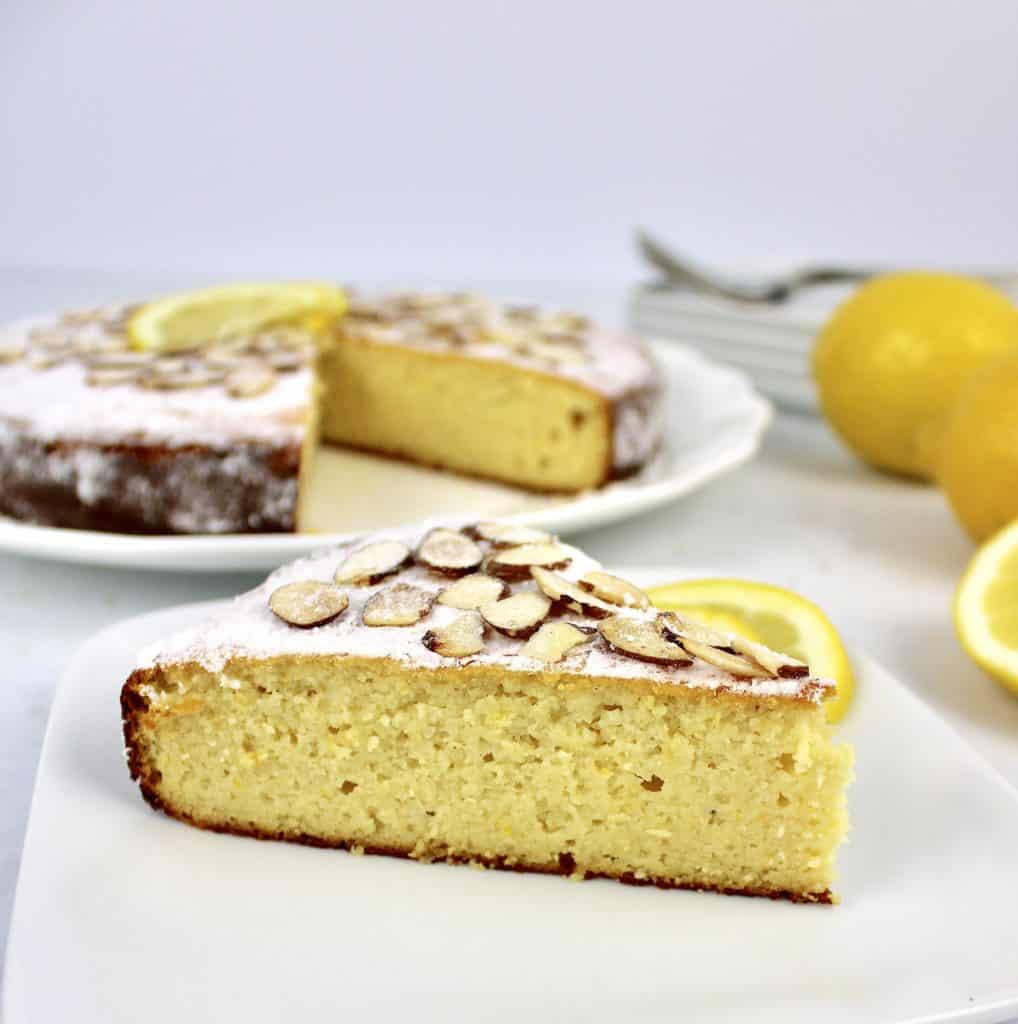 closeup of slice of lemon ricotta cake on white plate