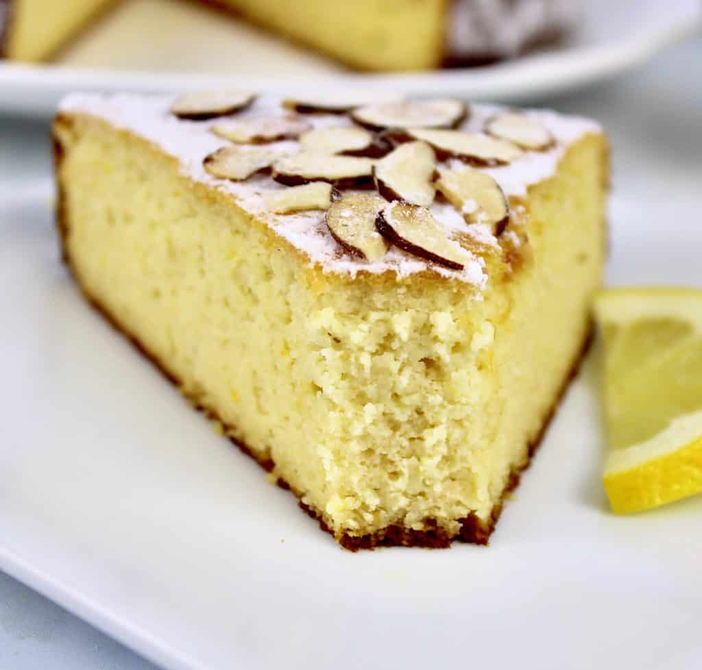 closeup of slice of lemon ricotta cake with bite taken out
