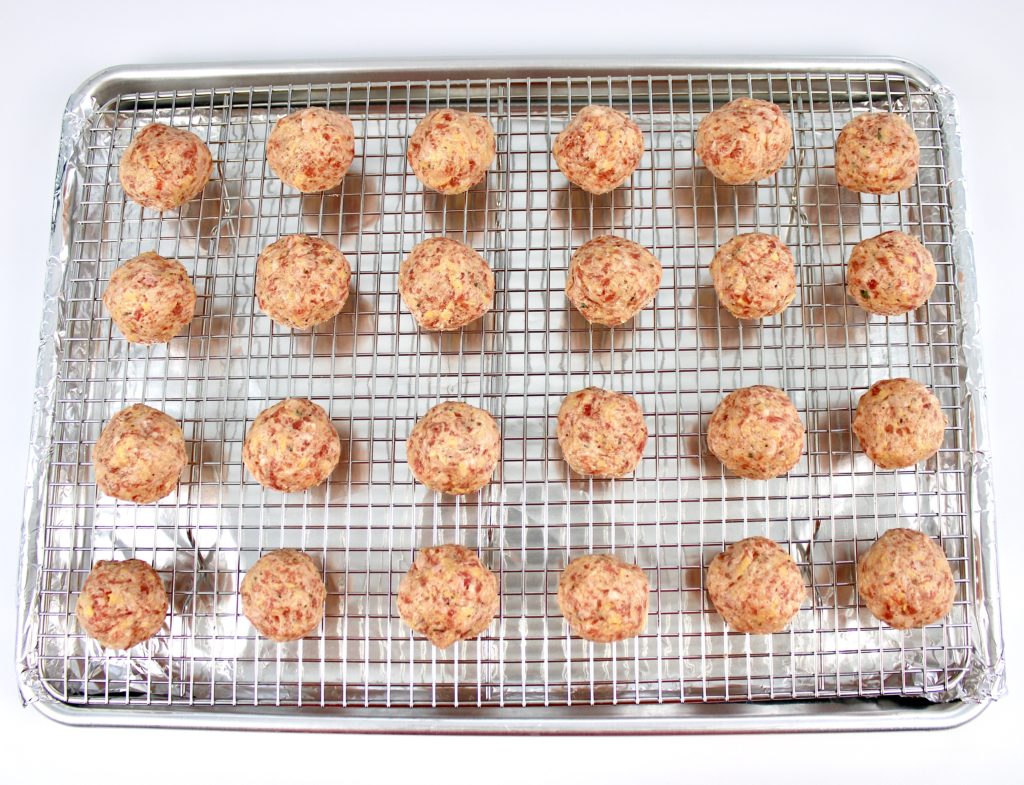 24 sausage balls on baking sheet with wire rack