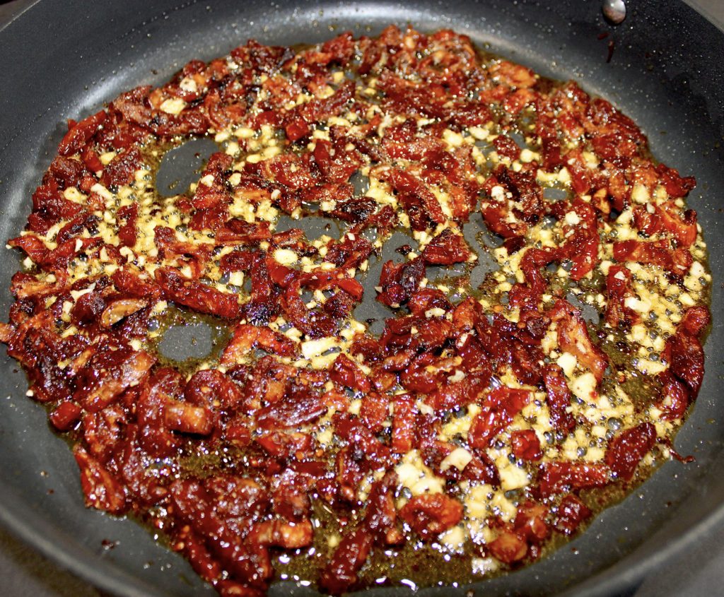sun dried tomatoes and garlic in skillet