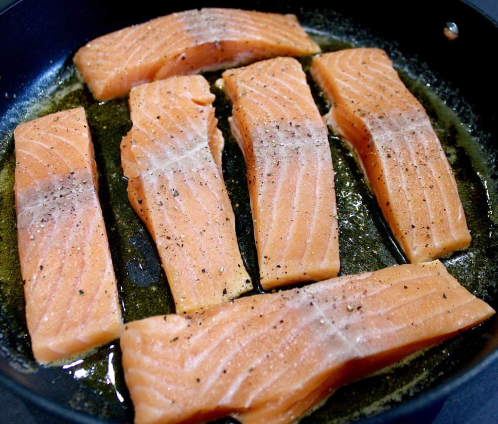 6 pieces of raw salmon in skillet