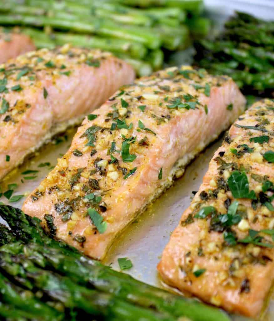 salmon on sheet pan with asparagus with garlic and chopped herbs