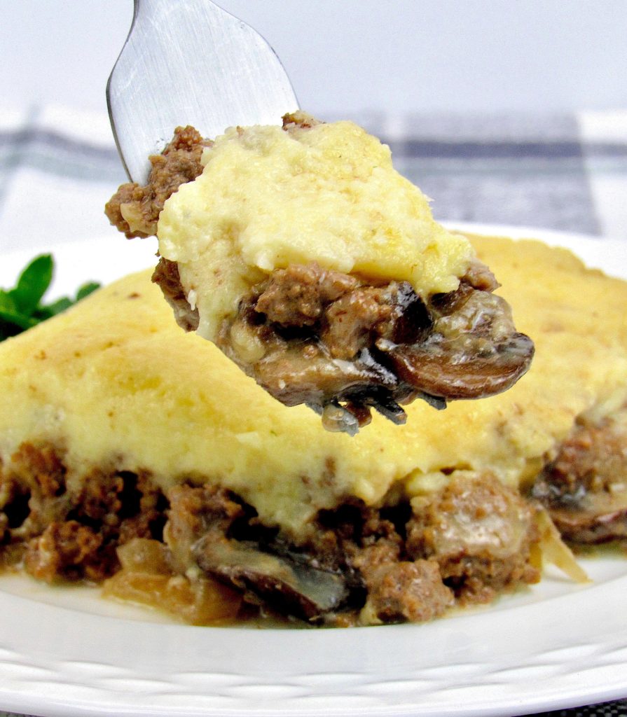 Keto and Low Carb Beef Stroganoff Casserole Slice on Plate with Bite on Held Fork
