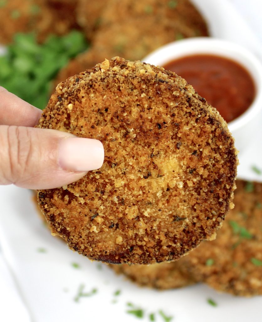 piece of fried eggplant being held up