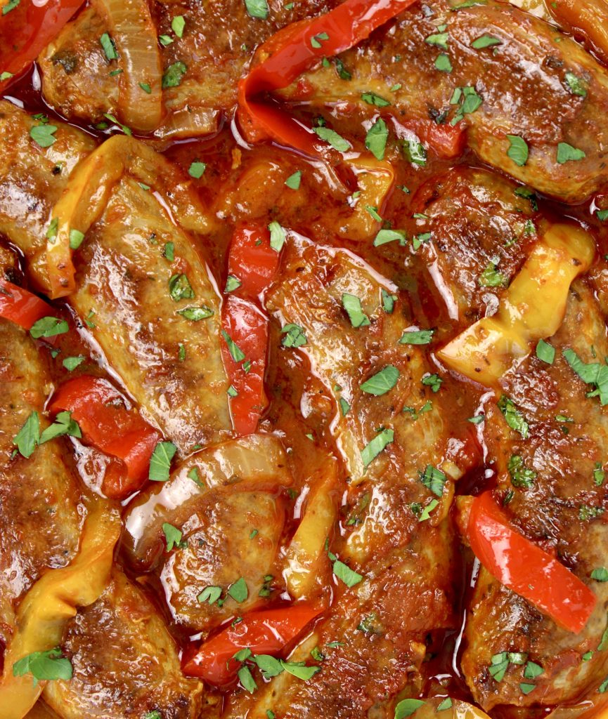 overhead closeup view of sausage and peppers in marinara sauce