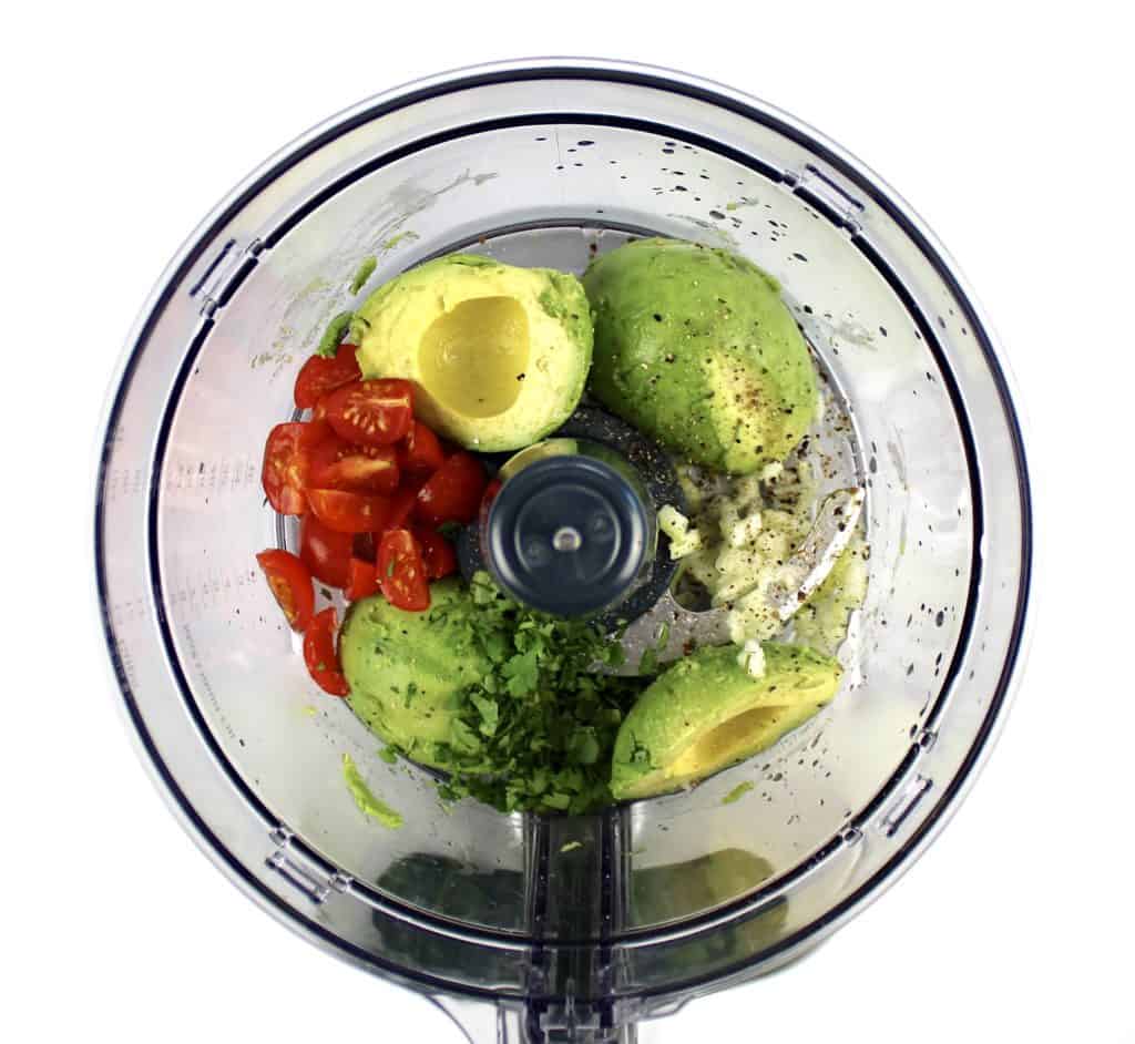 guacamole ingredients in food processor bowl unmixed