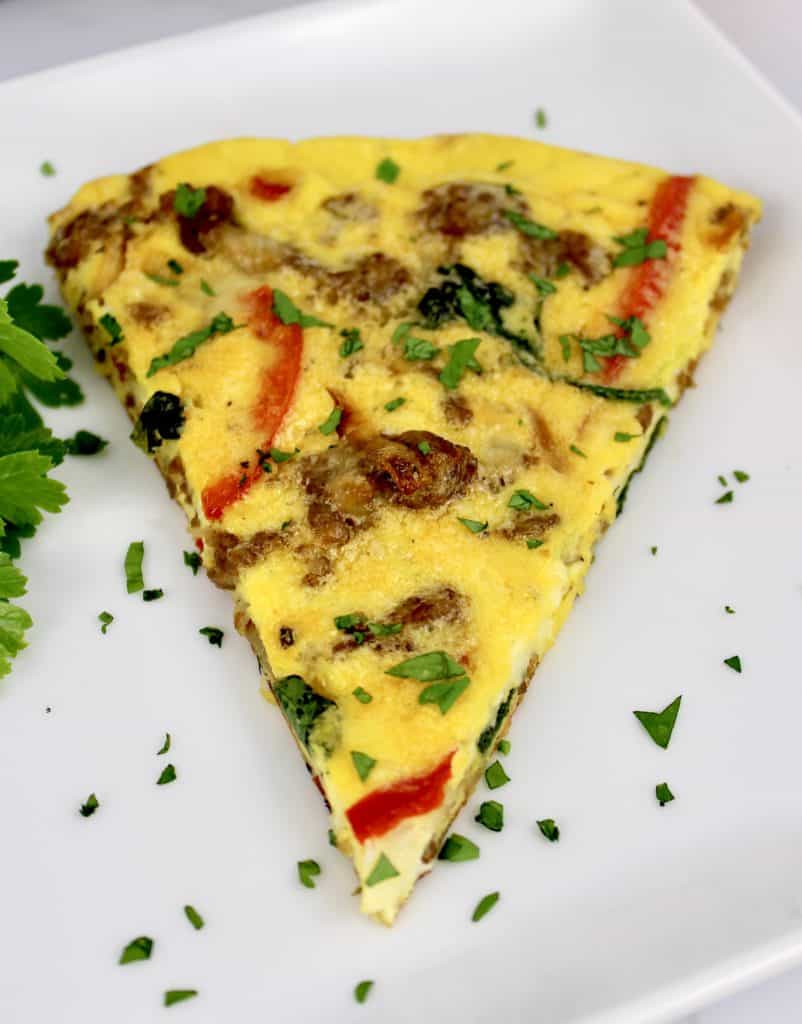 overhead view of slice of frittata on white plate
