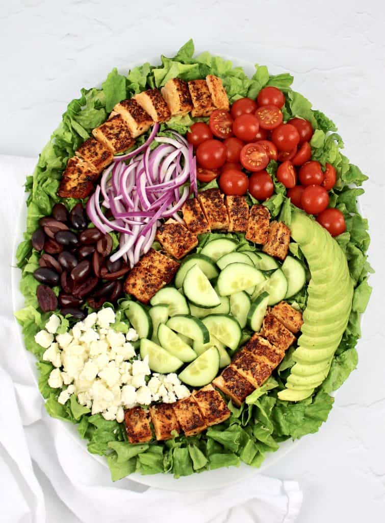 overhead view of salmon salad with sliced veggies on platter