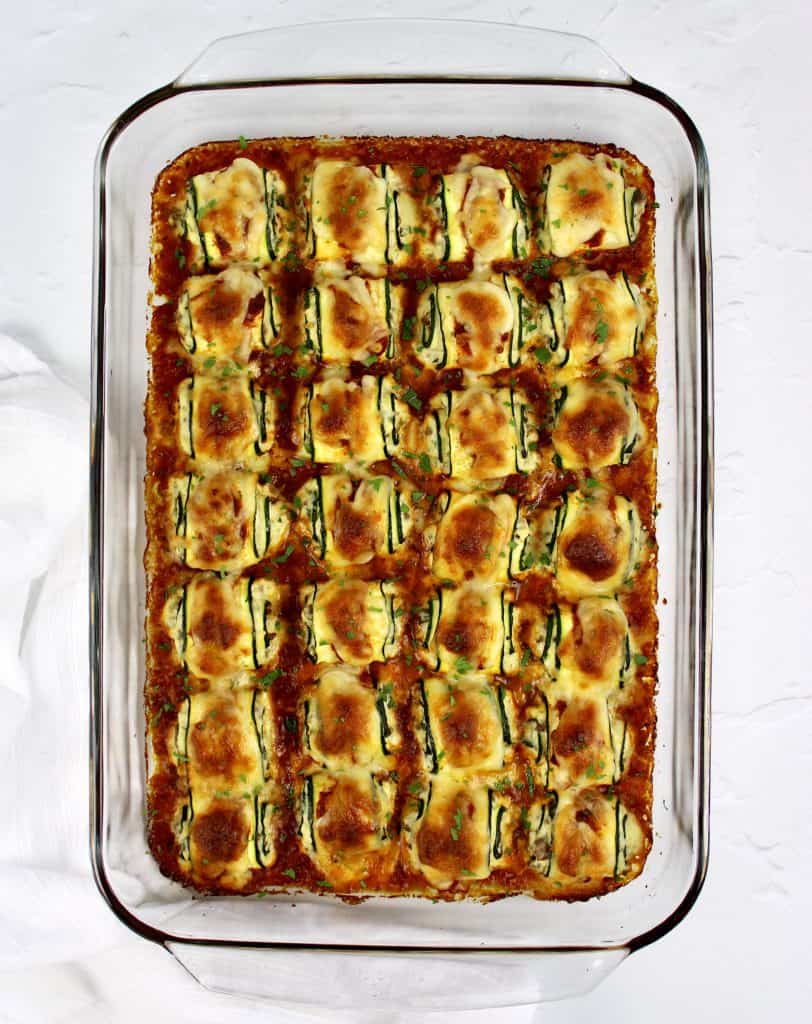 28 Zucchini Rollatini in glass baking dish with marinara sauce