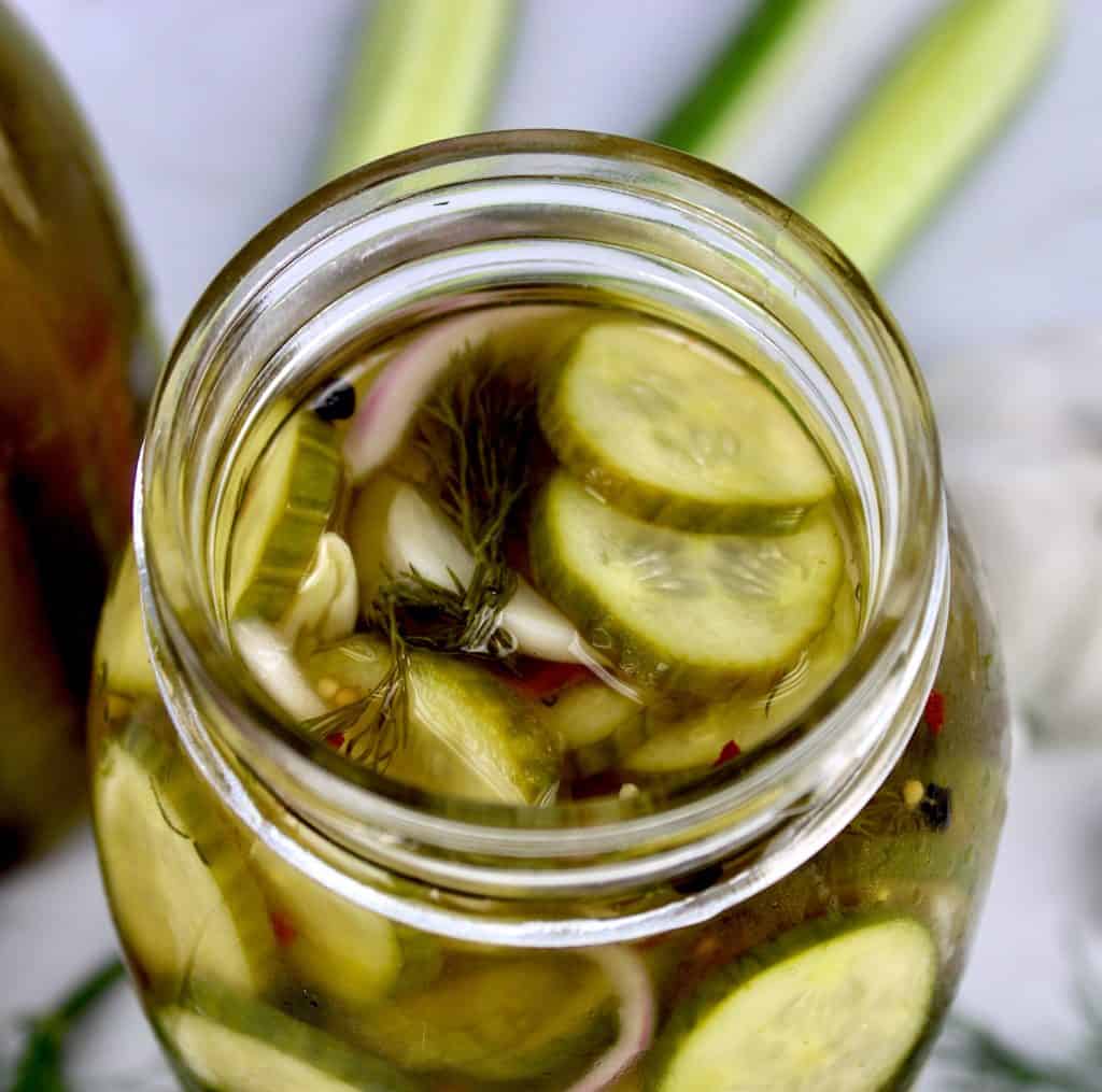 overhead view of open jar of pickle slices