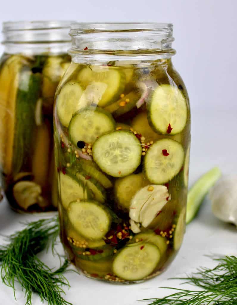 closeup side view of homemade pickle slices in jar