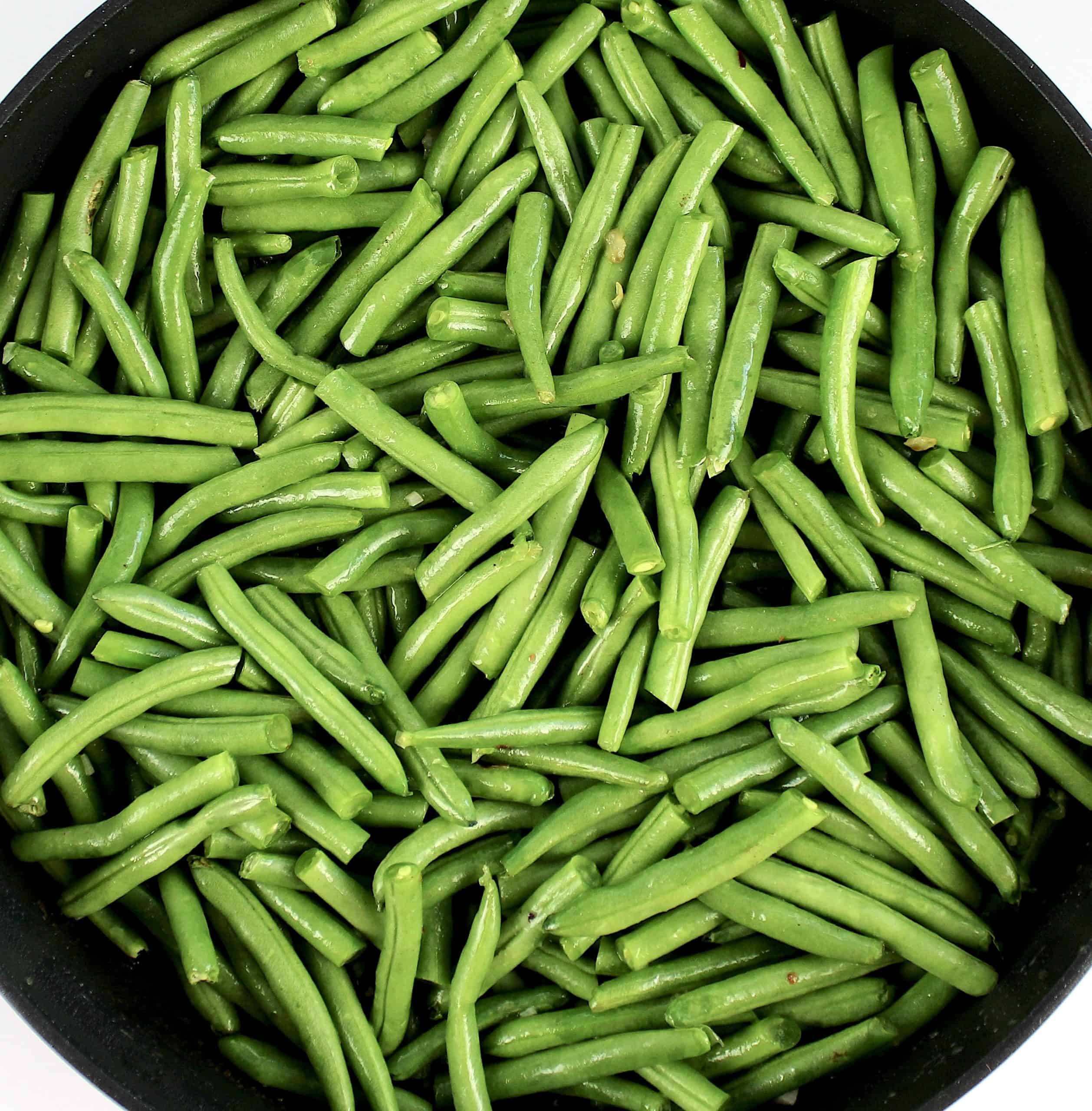 raw cut green beans in sklillet