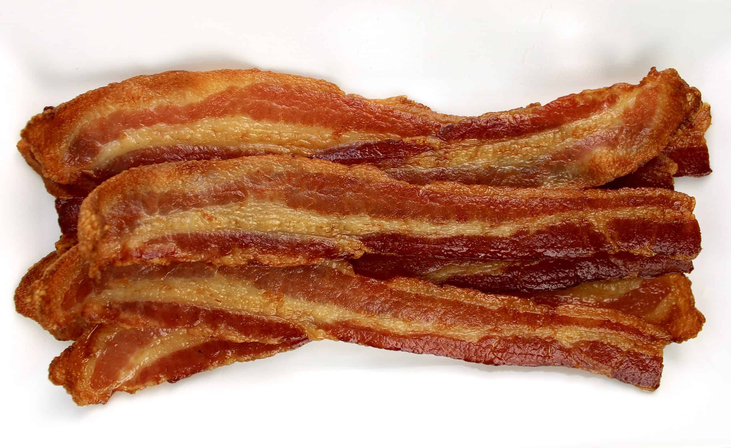 slices of cooked bacon on white plate