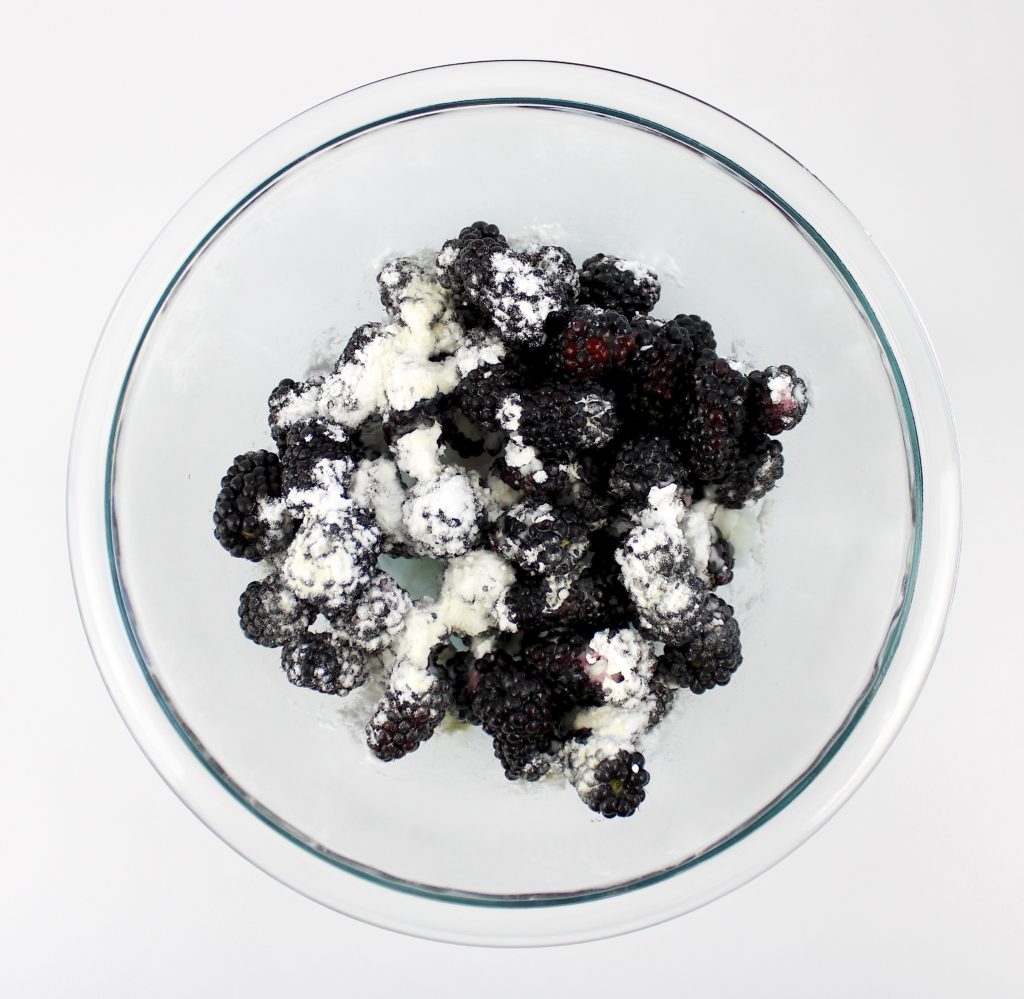 blackberries in mixing bowl with sweetener and lemon juice