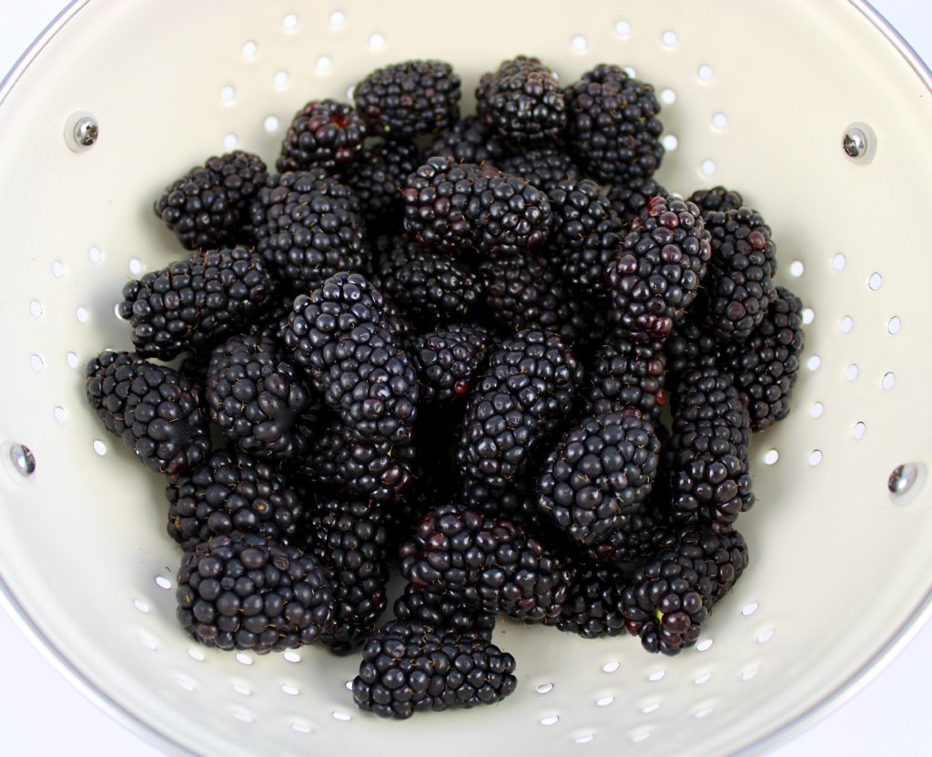 blackberries in white collander