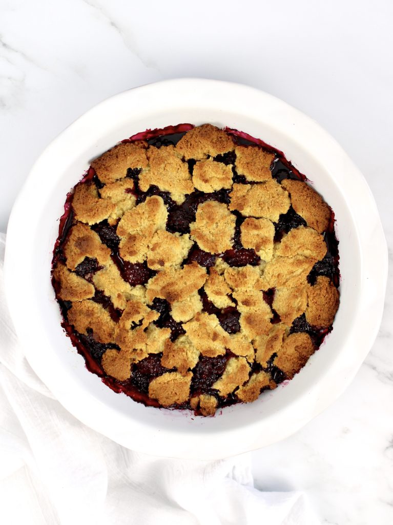 blackberry cobbler baked in white pie dish