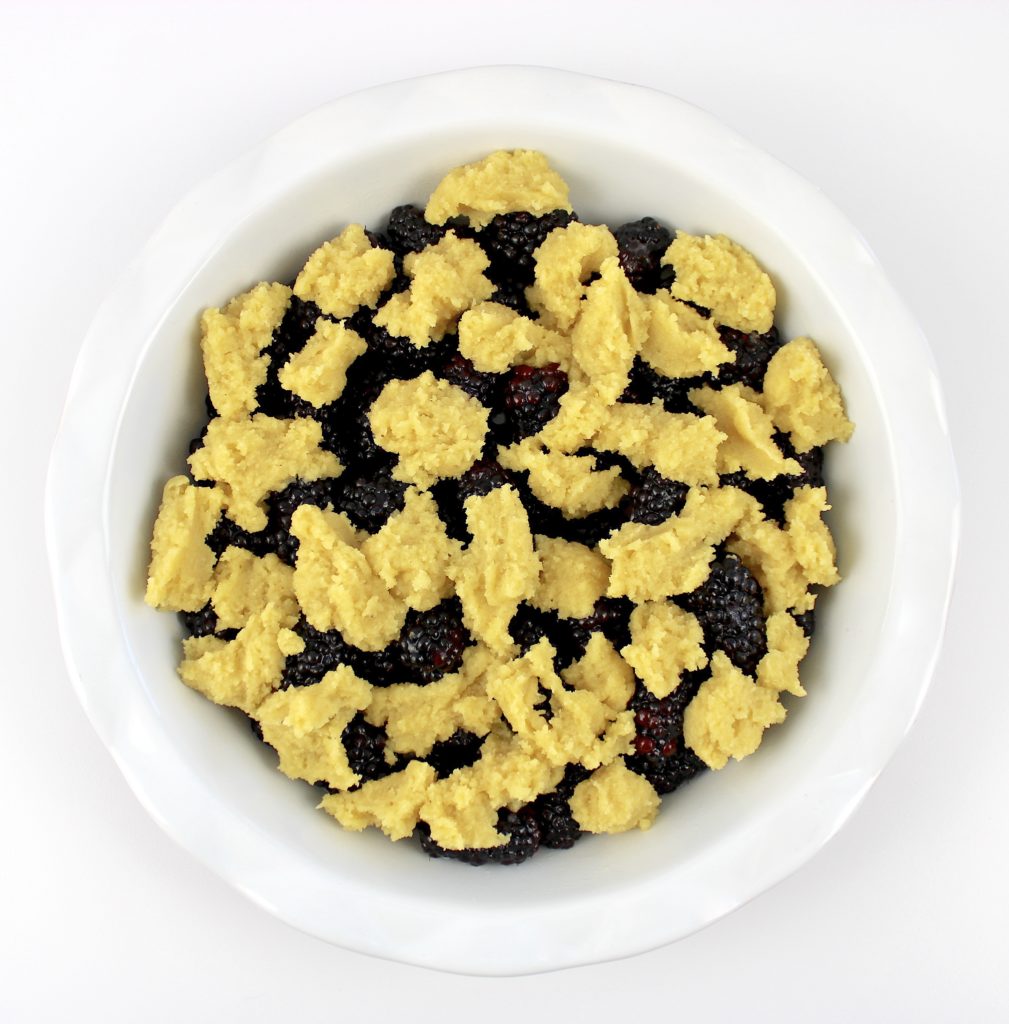 blackberry cobbler in white pie dish unbaked