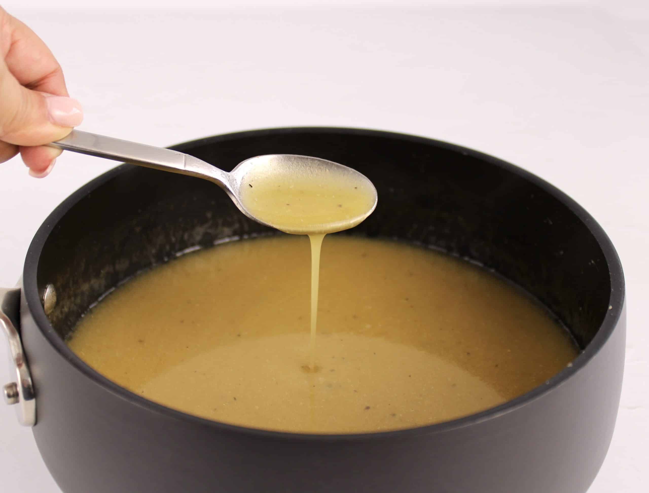 gravy being spooned in saucepan