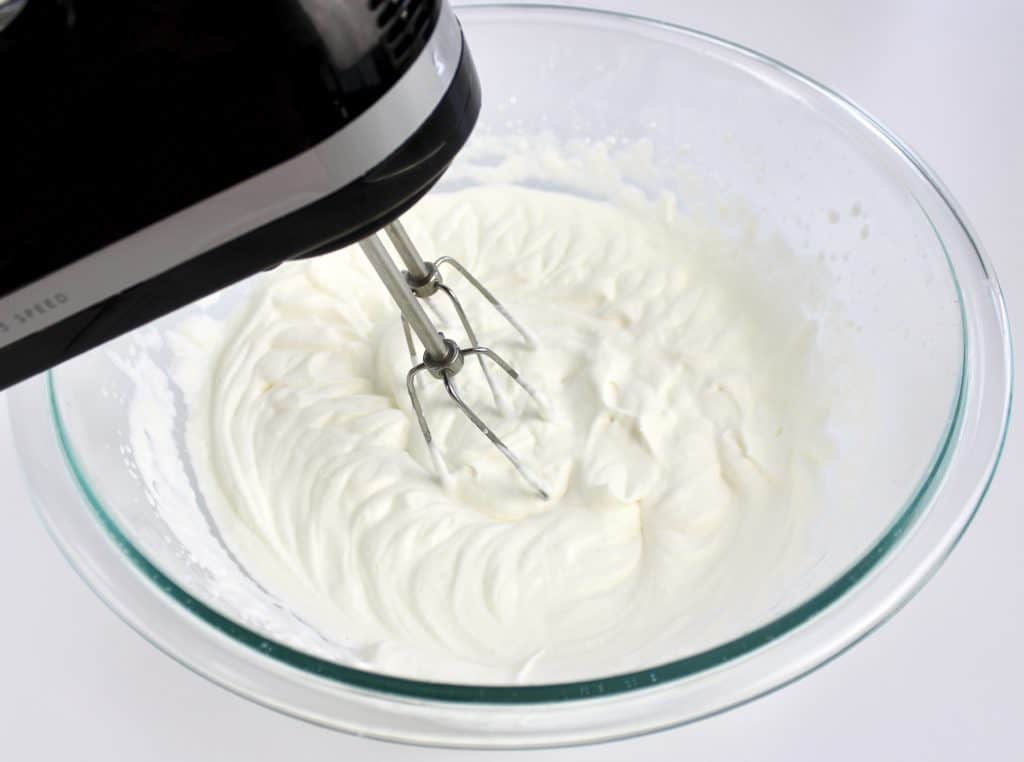 heavy cream being whipped with a hand mixer