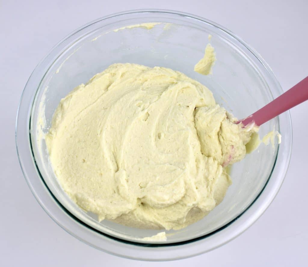 mascarpone cream mixture in glass bowl with pink spoon