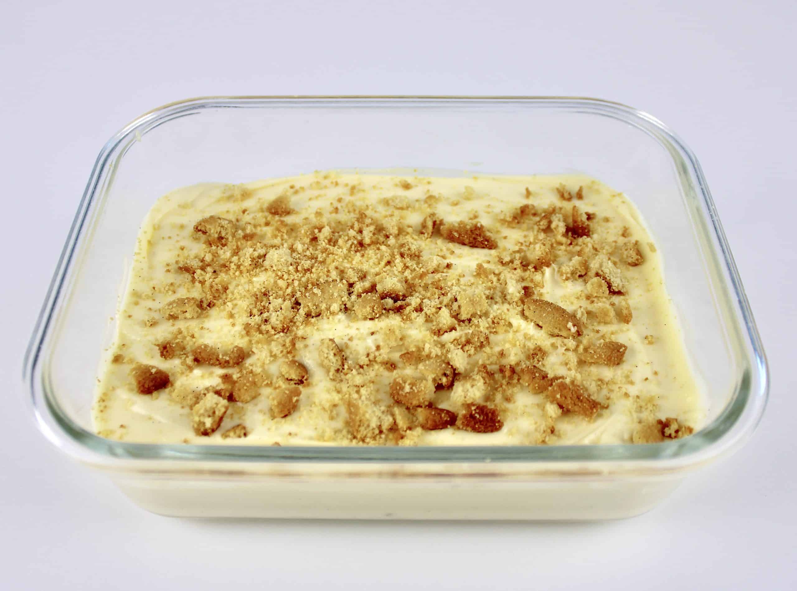 vanilla pudding in glass square dish with crushed nilla wafers on top