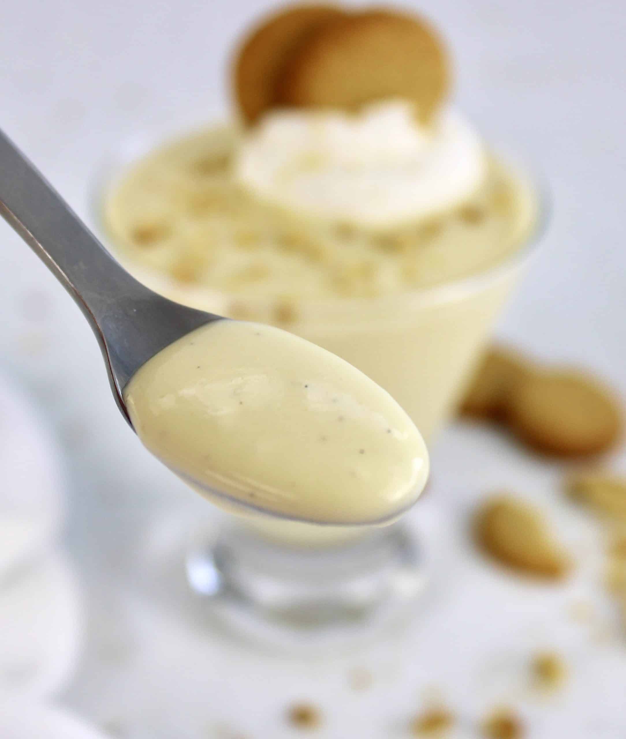 vanilla pudding in spoon with nilla wafer crumbs on top